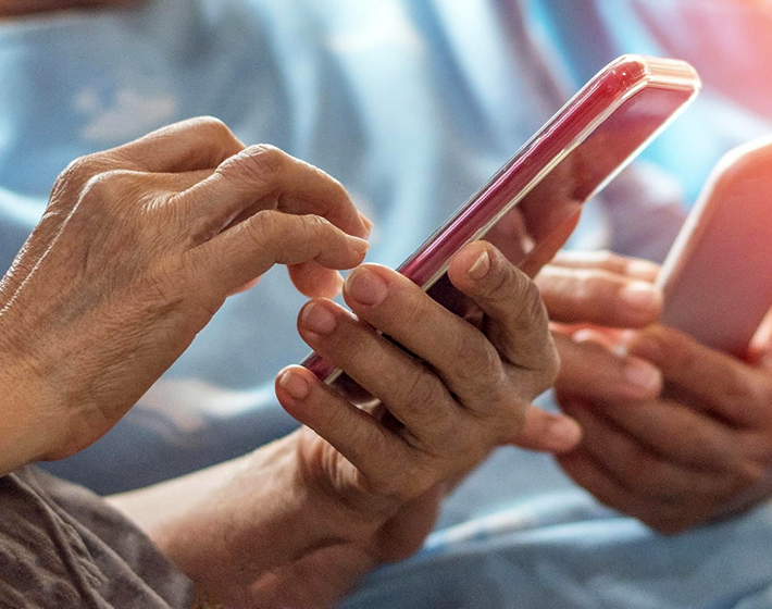 hands of seniors using their smartphones confidently