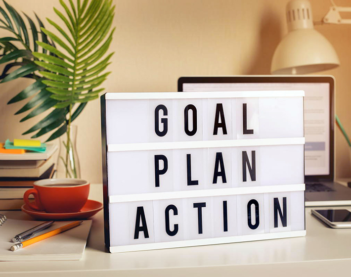 Goal, plan, action text on light box on desk table in home office