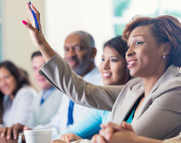 African American businesswoman raises her in a business setting