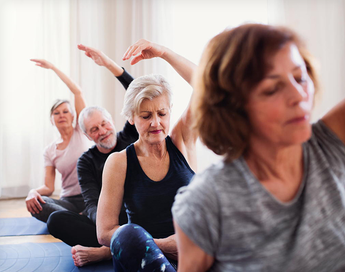 group of seniors doing yoga after covid-19 ends