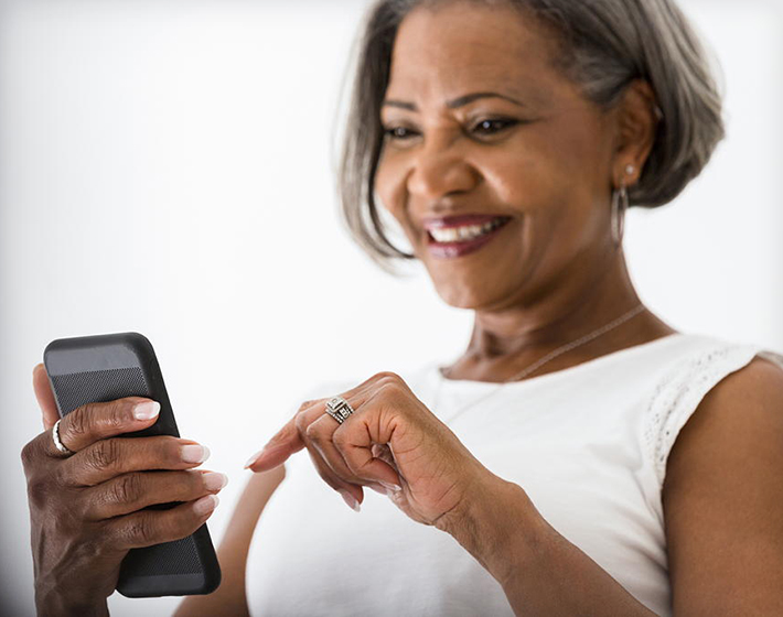 A Black woman reads an email from a drip campaign