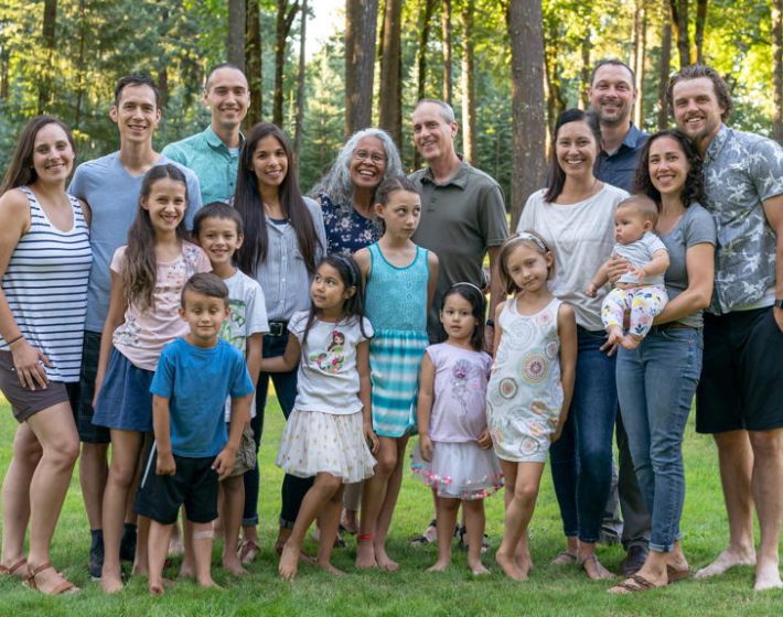 a multi generational family poses outdoors and represents family ties