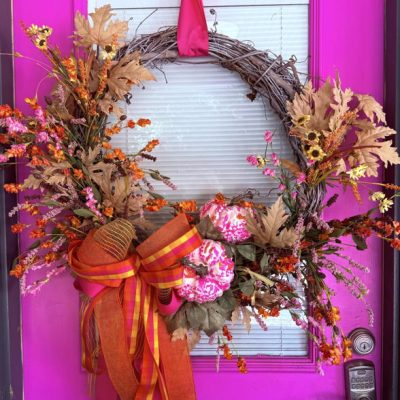 fall wreath hanging on fuchsia door and made by Angela