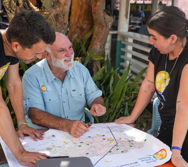 World Central Kitchen founder chef Jose Andres and team members look at a map of where they have kitchens to serve hungry people