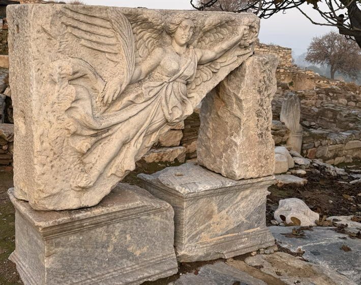 An ancient marble bas relief of an angel bringing tidings of joy