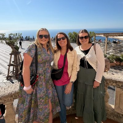 Maribeth and her 2 daughters pose with the Mediterranean Sea in the background