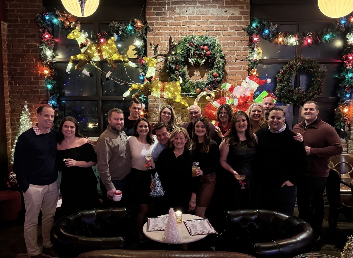The entire Rally team and significant others celebrate at a Christmas party.
